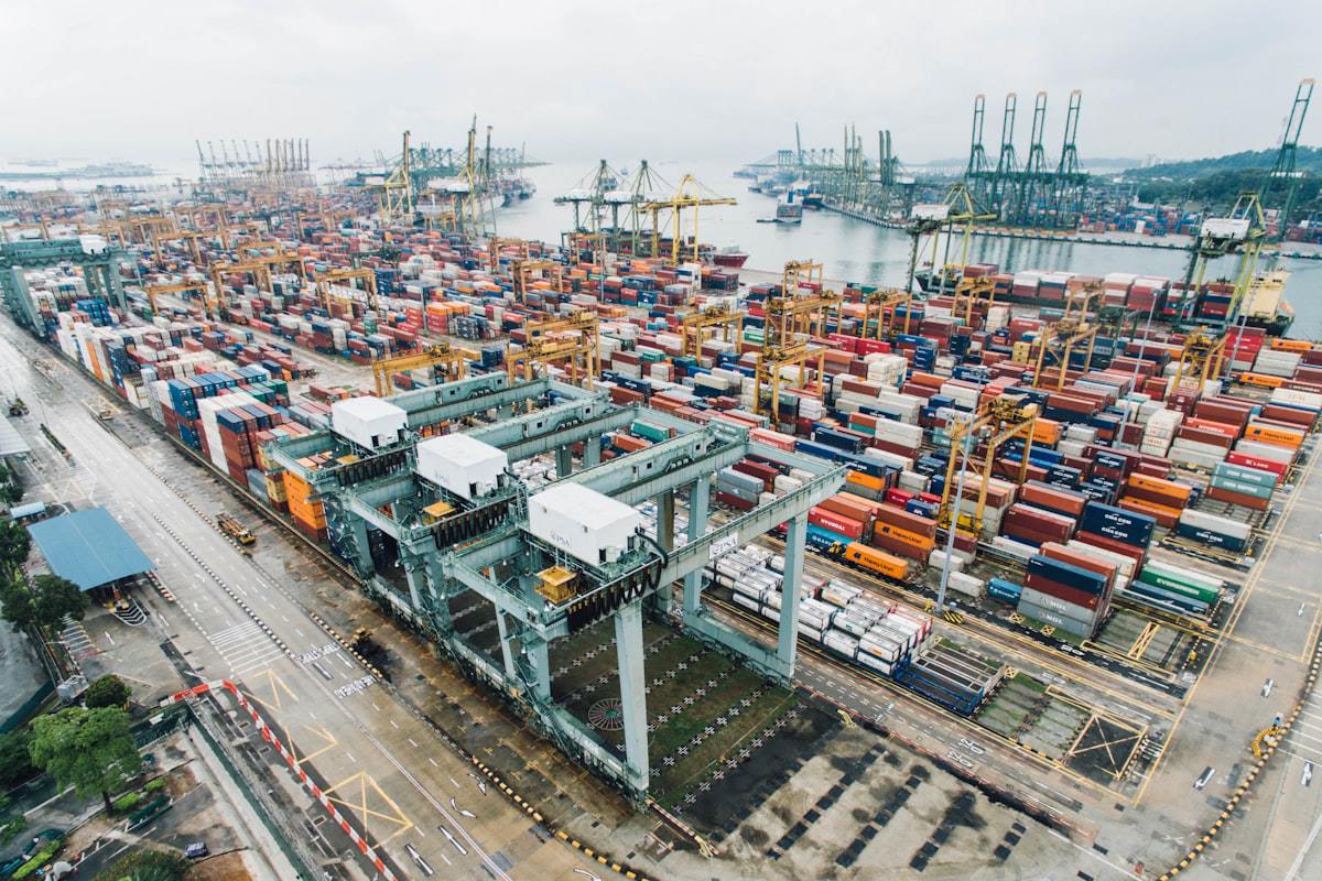 Aerial view of a container port with ship-to-shore cranes and stacked containers
